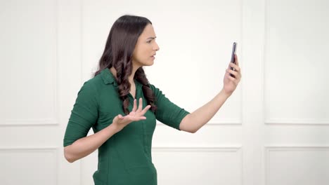 Sad Indian girl talking on a video call