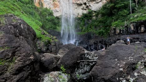 people exploring a scenic waterfall area