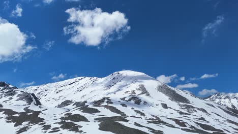 Aerial drone shot revealing the serene beauty of snow-covered slopes and valleys in Shinkula Pass.