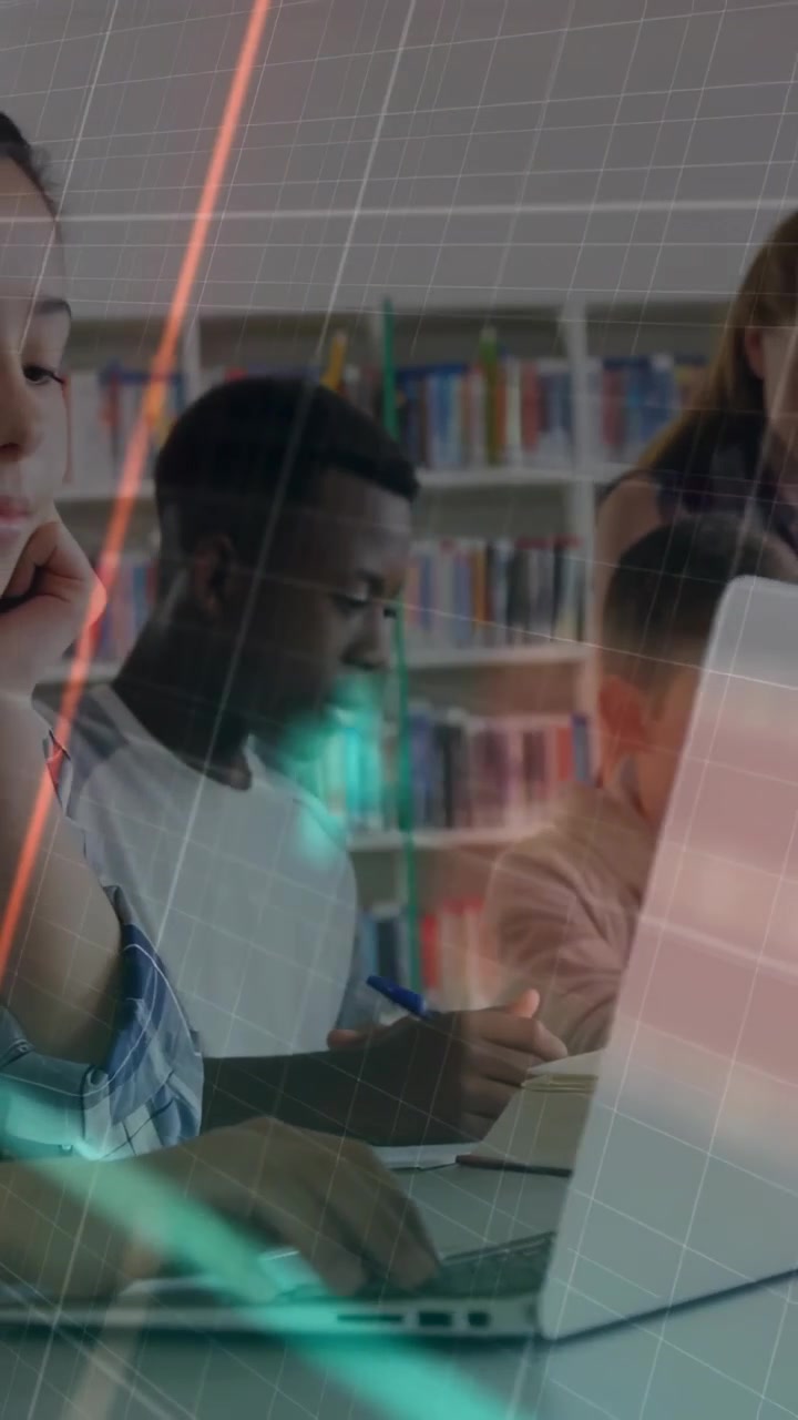 Vertical video: Teen student typing and noting in library, keys firing data arcs over group study
