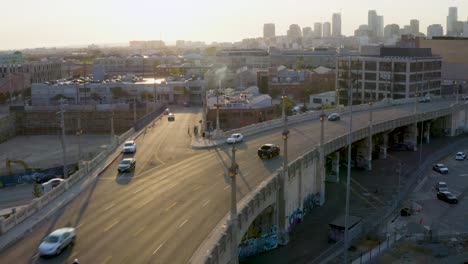 metropolis concept - cars driving on city road into downtown los angeles