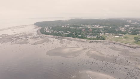 4k, flying over rocks by the sea shore - drone - pullout, high hotel