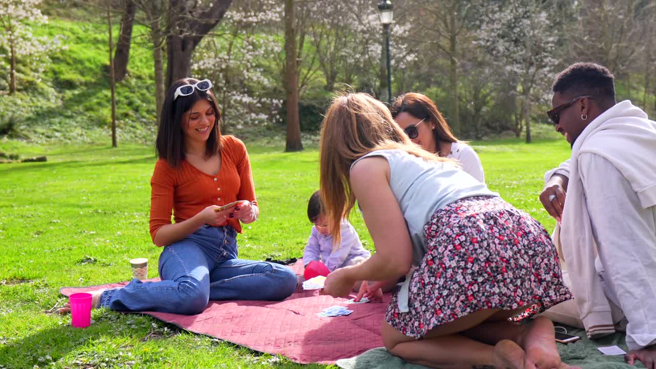 Friends playing cards at the park
