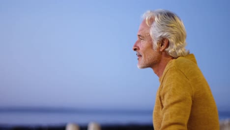 Senior-man-sitting-outdoors-against-sky-4k