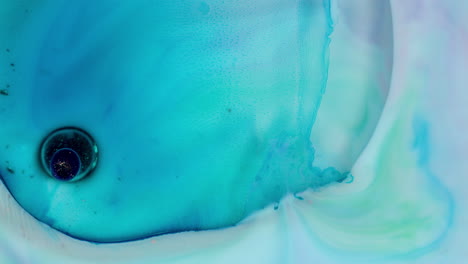 blue colors from paint inside water mixing in slow motion