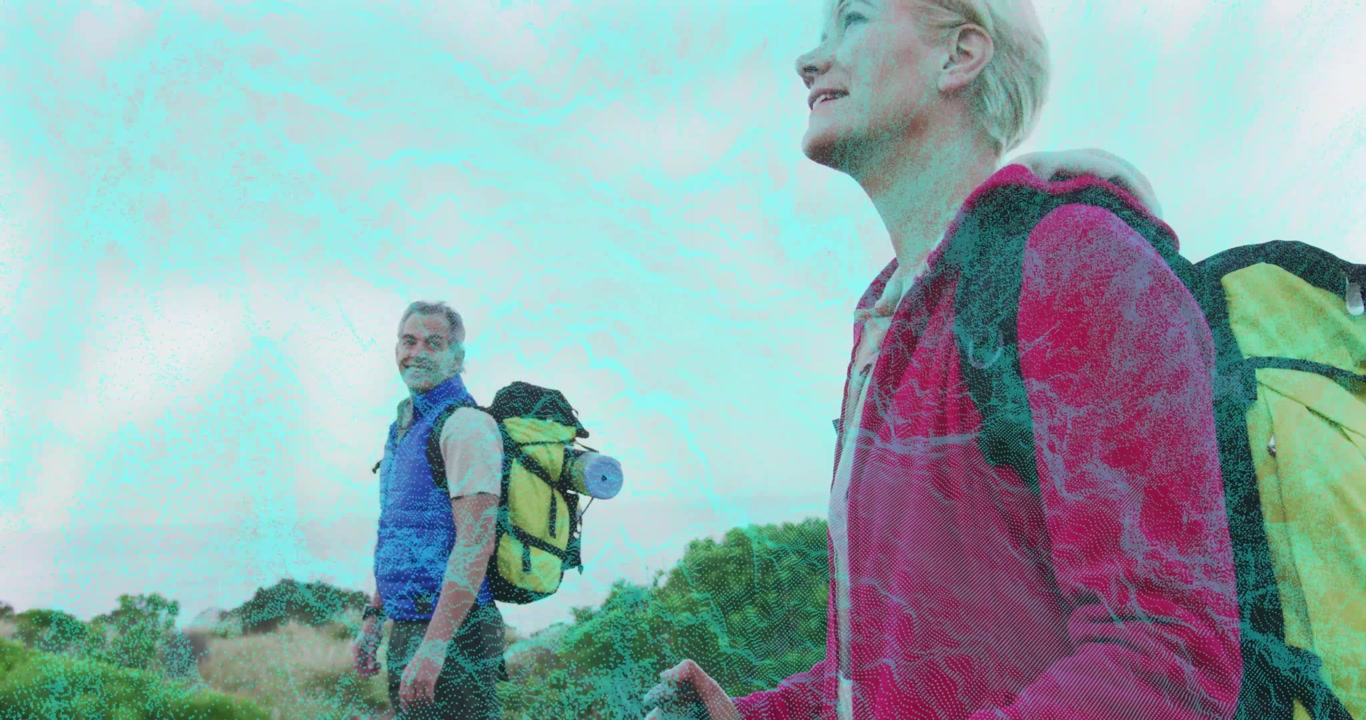 Male and female hikers halting on hillside at dawn scanning with poles starting hike for fitness