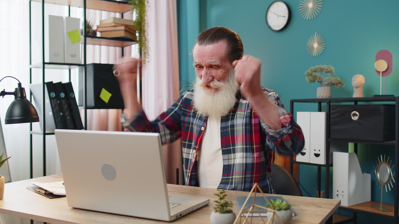 Happy senior man grandfather celebrate success win money in lottery on laptop get online good news