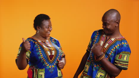 african american couple showing thumbs up symbol