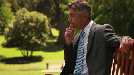 Thoughtful-businessman-in-the-park