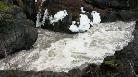 hvita river flowing through volcanic rocks in iceland