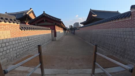 walking through the traditional wooden gate within the gyeongbokgung palace. - pov handheld shot