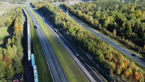 aerial view of a highway cutting through an autumn forest