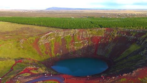 Kerid-Crater,-an-iconic-volcanic-wonder-in-Iceland,-features-a-mesmerizing-azure-lake-at-its-heart,-making-it-a-must-see-natural-attraction