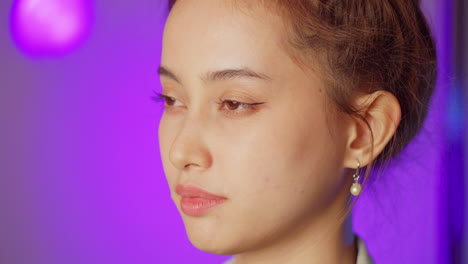close-up portrait of a woman with her eyes closed and she opens her eyes a few seconds later.