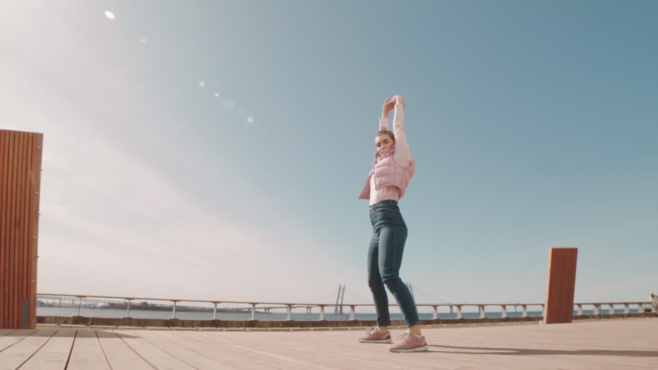 Young Woman Dancing on City Deck