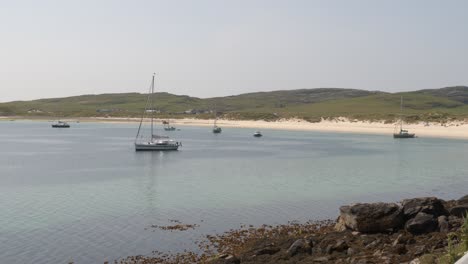 shot of the yachts anchored at vatersay beach near castlebay on the island of barra