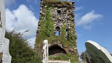 castle and headstones ancient ruined castle in waterford ireland on a summer day