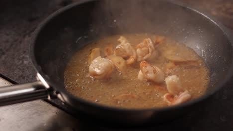 shrimp and vegetables cooking in pan