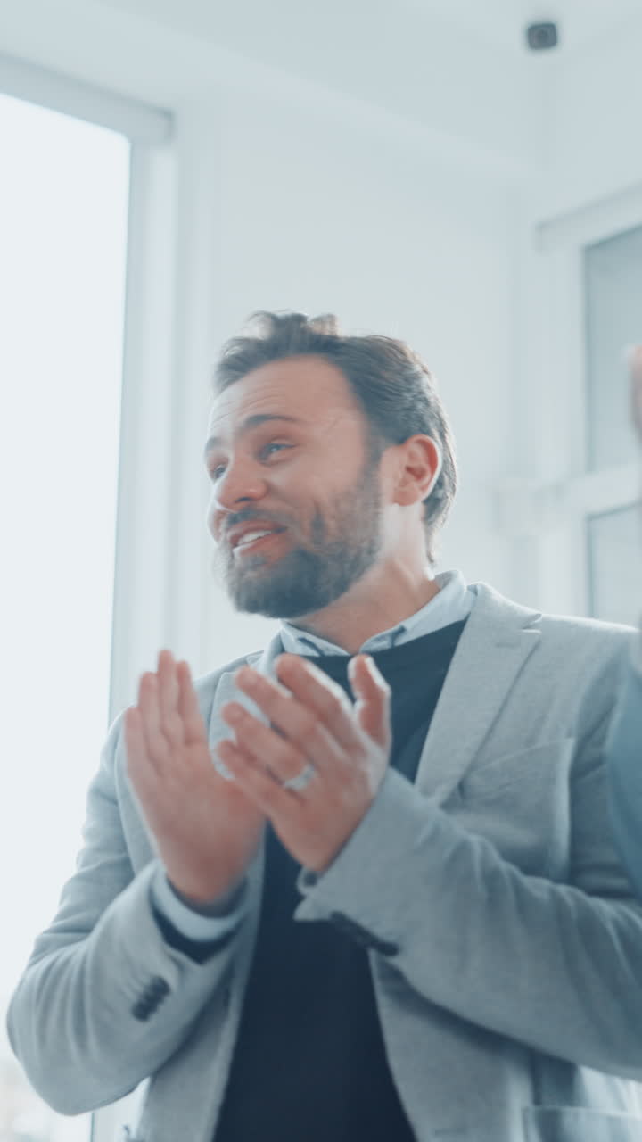 Happy Business Team Clapping and Celebrating Success in Office