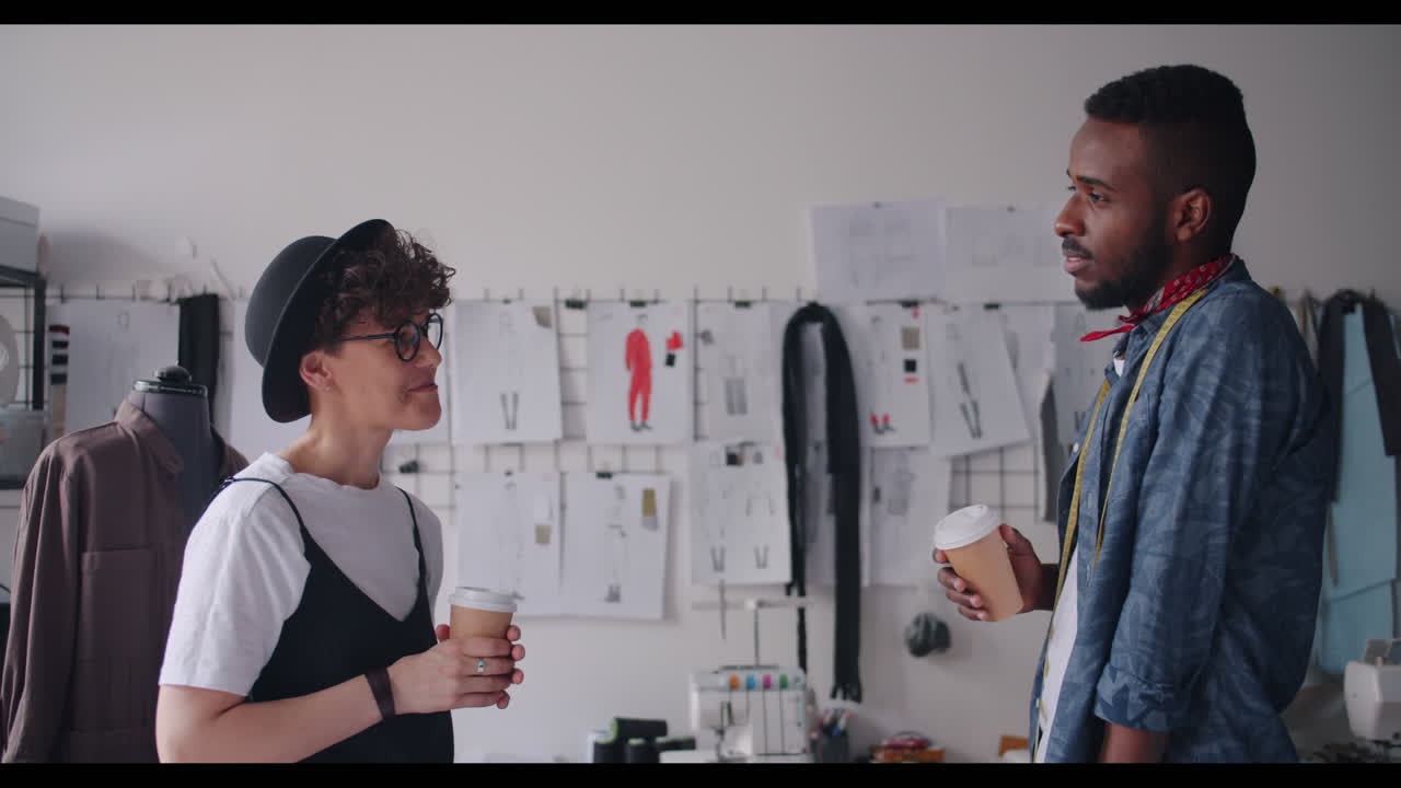 Fashion Designers Discussing Designs Over Coffee