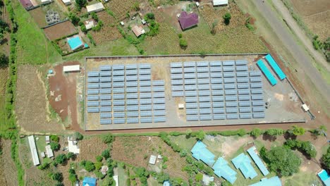 drone flying over solar panel cell farm in kenya