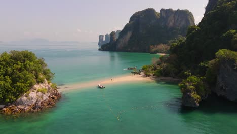 4K-aerial-drone-footage-of-couple-walking-on-the-beach-in-Thailand,-Asia,-Sandbar,-Andaman-sea,-Pakbia-Island