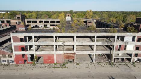 derelict multi story building in detroit city, aerial side fly view