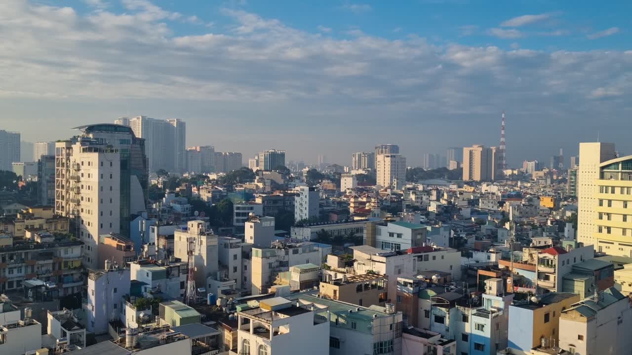 Sunny morning view over Ho Chi Minh City’s rooftops stretching to the horizon, captured from a high-rise, revealing a lively and ever-growing urban landscape