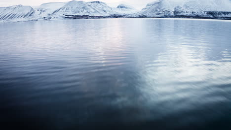 drone shot revealing the city longyearbyen from the fjord