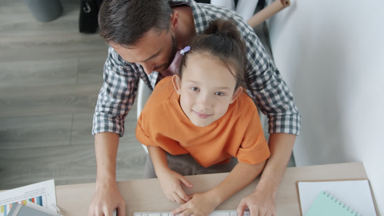 Father and Daughter Working Together at Home