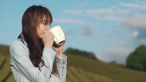 woman enjoying a drink in a tea plantation