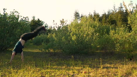 slow-motion-footage-of-teenage-boy-doing-somersaults-in-beautiful-surroundings