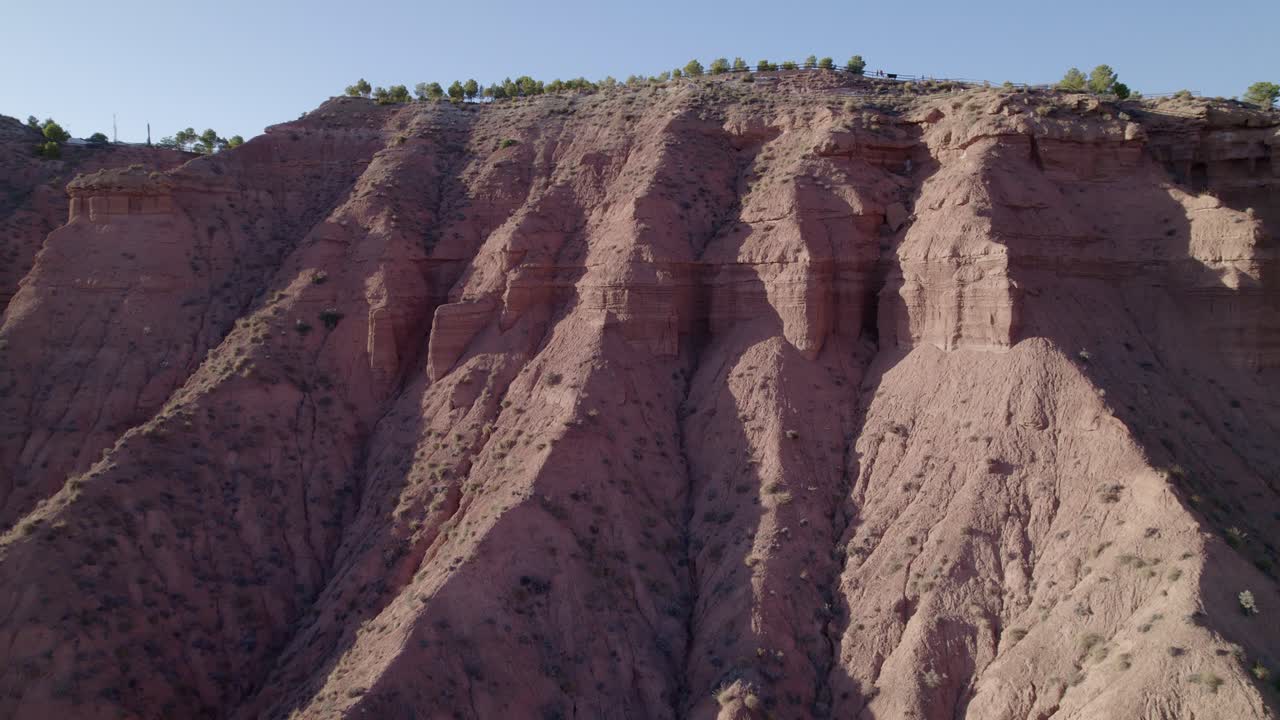 Ravine and gullies at sunset, aerial view. Badlands caused by severe erosion. Climate change and desertification. Gorafe desert, Granada. Spain