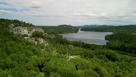 aerial view of rocky wilderness with lake in the distance