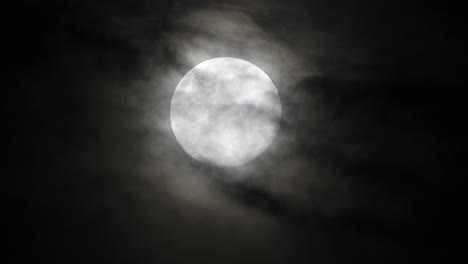 Haunted-creepy-near-full-moon-with-eerie-dark-clouds-moving-past-in-the-foreground,-perfect-for-Halloween,-scary-dark-themed,-celestial-footage