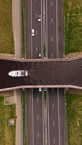 Highway lanes running under waterway canal aqueduct in netherlands