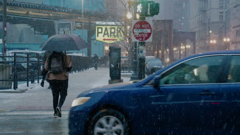 a woman crosses a street in the snow in slow-motion