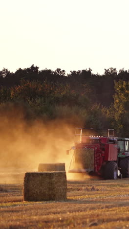 tractor at work on a field. universal tractor harvesting straw in the field
