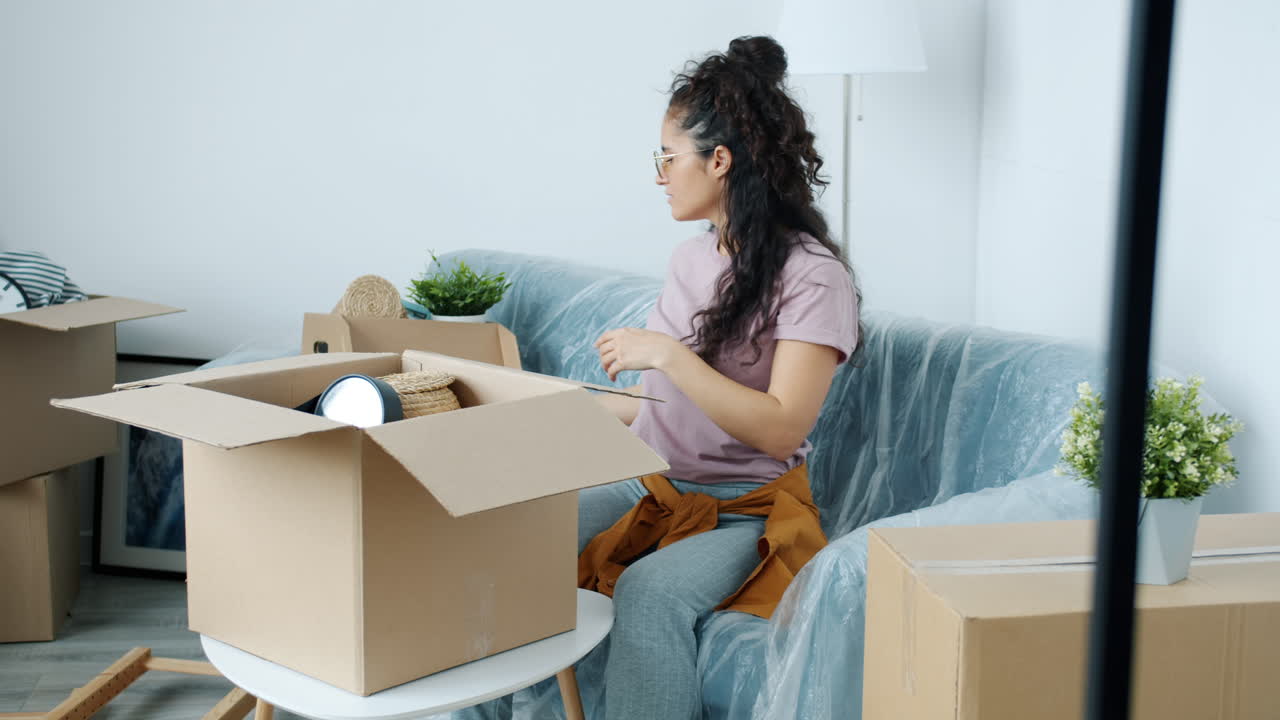 Woman unpacking boxes in a new home
