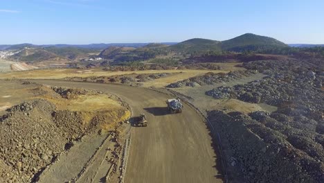 Heavy-machinery-working-in-te-riotinto-open-pit-copper-mine-aerial-shot