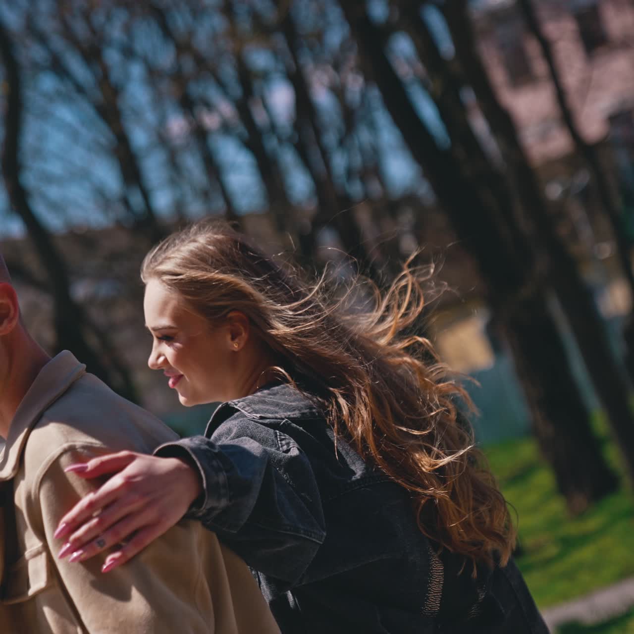 Guess who. Happy couple in love meeting in the park. Woman closed eyes of her boyfriend while standing behind him. Romantic date concept