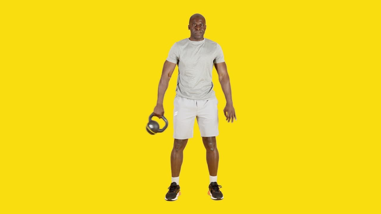 Strong african man doing around the world exercise with kettlebell