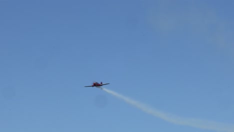 single stunt plane executing loops in clear sky