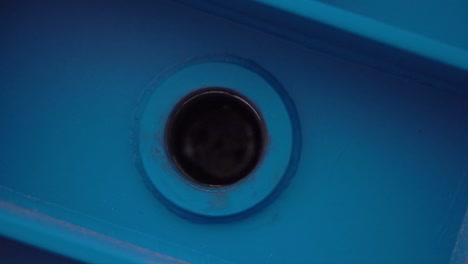 close-up of a blue plastic component with a round hole