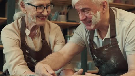 loving couple senor man and senor woman are enjoying themselves during the pottery art