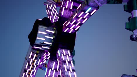 colorful carnival ride spinning against sky