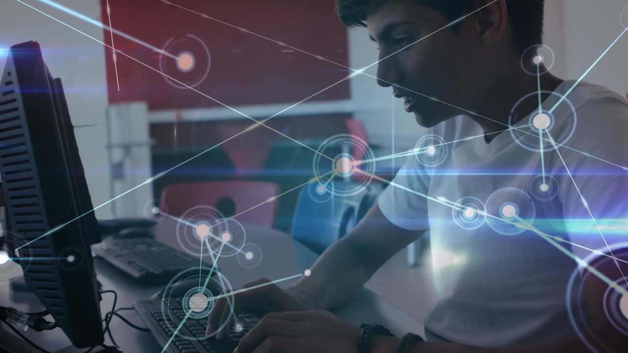 Glowing network of connections against indian boy using computer in the class at school