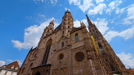 vienna, austria - june 9, 2025: vienna's beautiful blue skies. tourists admire stunning gothic architecture at st. stephen's cathedral in vienna, austria on a sunny day