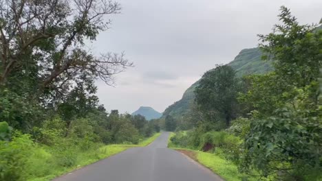 Driving-through-Tamhini-Road-Ghat-on-cloudy-day,-India