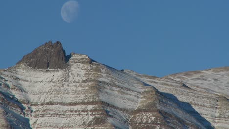 a full moon rises over the andes mountains in patagonia 1